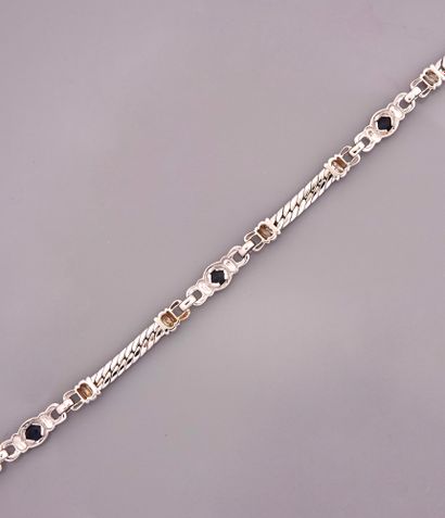 null Bracelet in white gold, 750 MM, decorated with three sections of oval sapphires...