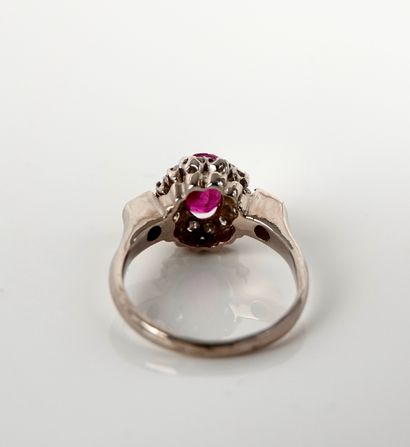 null Ring in white gold, 750 MM, centered by an oval ruby in a row of diamonds, can...
