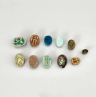 null Set of eleven scarabs with inscriptions on the plate, one mounted as a pendant
Frit...