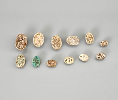 null Set of twelve scarabs with inscriptions on the plate
Steatite or Frit
1 to 2.2...