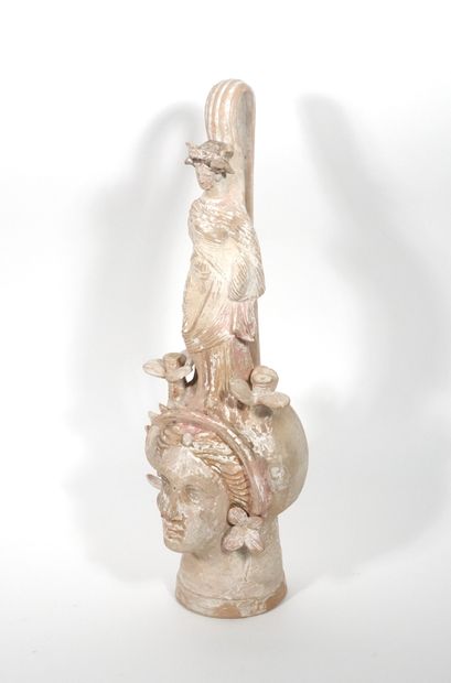 null Dummy vase decorated with a female head surmounted by flowers and a draped female...