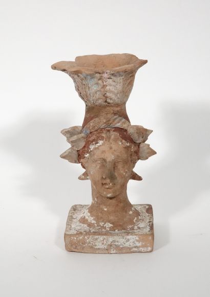 null Female head decorated with a foliage forming a symbolic candlestick 
Terracotta...