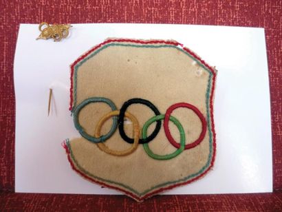 null Deux pièces : a) écusson olympique en tissus avec liséré tricolore et anneaux...