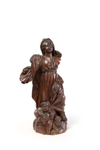 null Vierge
Bois naturel sculpté représentant une sainte femme sur des nuées peuplées...