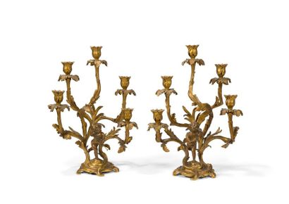 null LARGE PAIR OF BRONZE PATINIAN AND GOLDEN
BRONZE CANDELABRES decorated with children's...