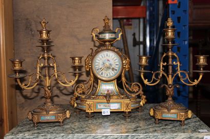 null Gilded bronze and polychrome porcelain mantel set, including a clock with a...