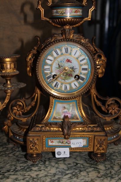 null Gilded bronze and polychrome porcelain mantel set, including a clock with a...