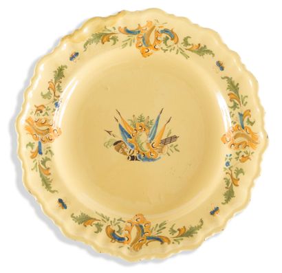 null MOUSTIERS

EARTHENWARE RIM PLATE

with polychrome decoration on a yellow background...