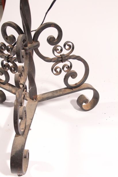 null Wrought-iron floor lamp with four arms of light decorated with windings, tripod...