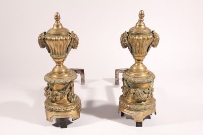 null Pair of bronze andirons, decorated with vases, ram's heads and fruit garlands

nineteenth...