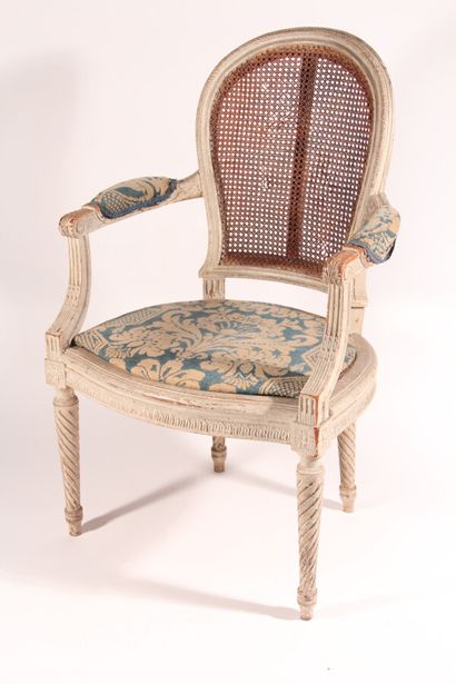 null A pair of armchairs in painted and carved wood, backrests made of cane and embroidered...