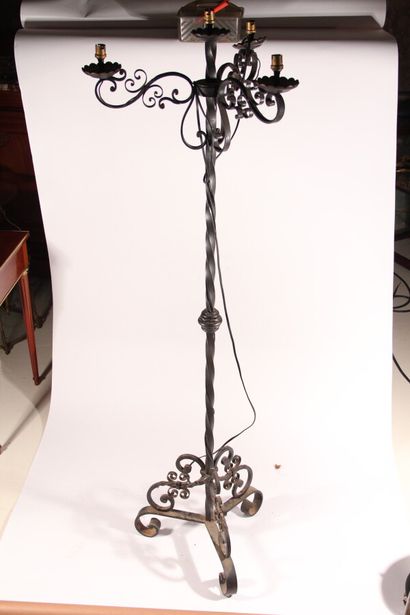 null Wrought-iron floor lamp with four arms of light decorated with windings, tripod...