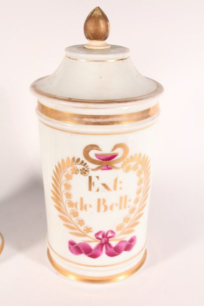 null Two white porcelain medicine jars with gold fillets, one with gilded decoration...