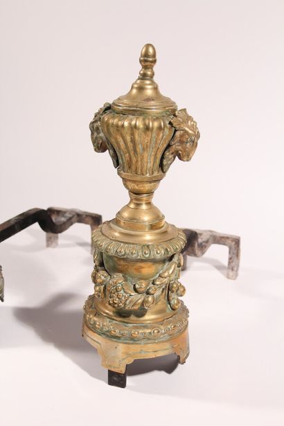 null Pair of bronze andirons, decorated with vases, ram's heads and fruit garlands

nineteenth...