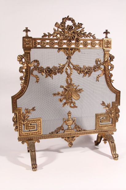 null Gilded metal mantel screen with garland of flowers and musical attributes

Late...
