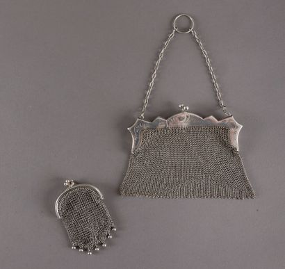 null A silver mesh purse with two compartments and a silver mesh bag, the setting...