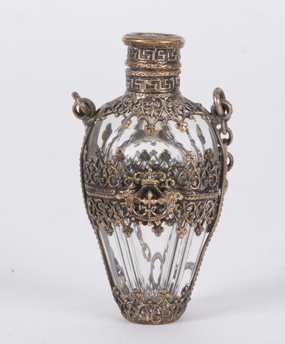 null A crystal flask with cut sides, the silvered metal mesh frame decorated with...