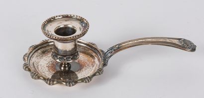 A silver plated hand candlestick, the contours...