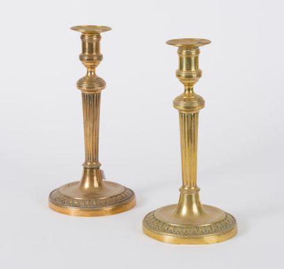 null Pair of brass torches from the 19th century, round base with foliage decoration,...