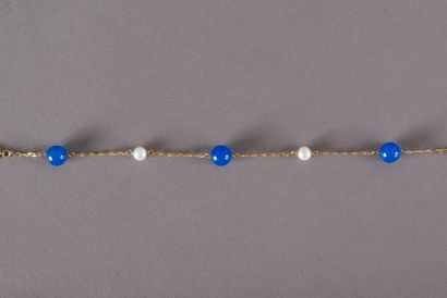 null Flexible bracelet in yellow gold 750 thousandths decorated with pearls of culture...