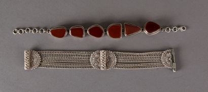 null Two supple silver bracelets, one set with carnelian stones, gross weight 86...