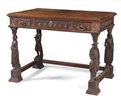 null WRITING TABLE IN MOULDED AND CARVED OAK

the belt decorated with fleurons opening...