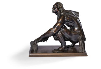 null BRONZE FIGURE WITH BROWN PATINA

representing L'Arretino after the Antique.

Late...