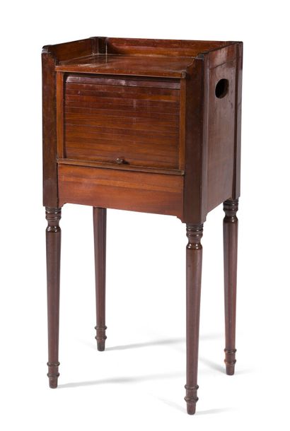 null MAHOGANY BEDSIDE TABLE

opening with a curtain and a drawer, resting on tapered...