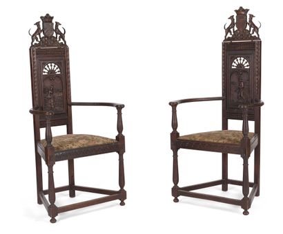 null PAIR OF HIGH BACK ARMCHAIRS IN STAINED AND CARVED OAK

carved with a coat of...
