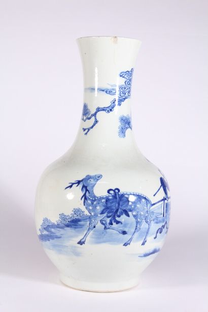 null A blue and white porcelain vase with a figure and deer in a landscape

China,...