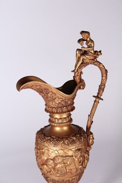 null A large ormolu ewer with a revolving decoration of love birds and friezes of...