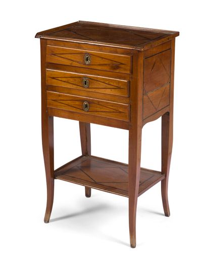 null A fruitwood chest of drawers with inlaid fillets, opening to three drawers forming...