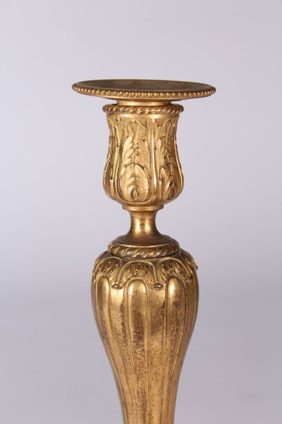 null Gilt bronze candlestick decorated with palmettes, interlacing and foliated friezes,...