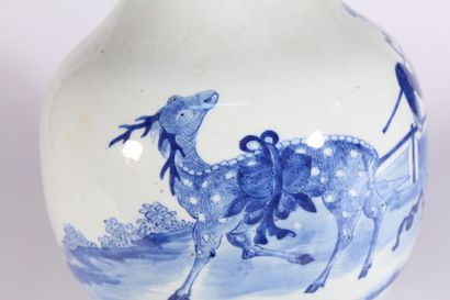 null A blue and white porcelain vase with a figure and deer in a landscape

China,...