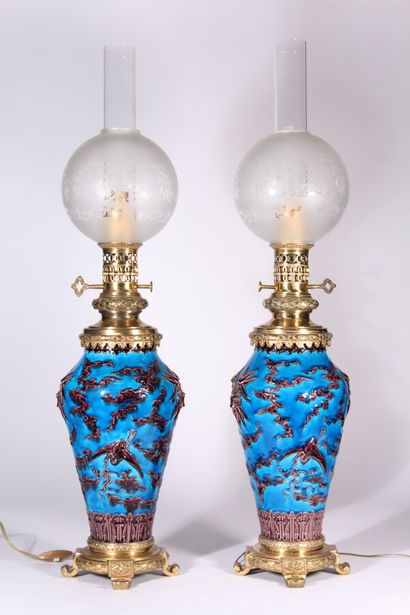 null Pair of earthenware oil lamps with a Far Eastern decoration of cranes and clouds...