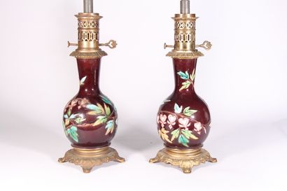 null Pair of oil lamps, earthenware baluster base with enamelled flowers 

Early...