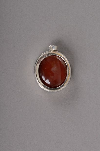 null A silver pendant with an intaglio on a carnelian with a profile of a helmeted...