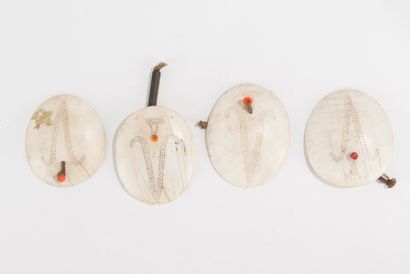 null Two pairs of shell earrings engraved with a symbol indicating the owner's status...
