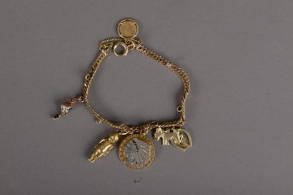null A gold-plated flexible bracelet with six charms: a 1911 five dollar coin embellished...