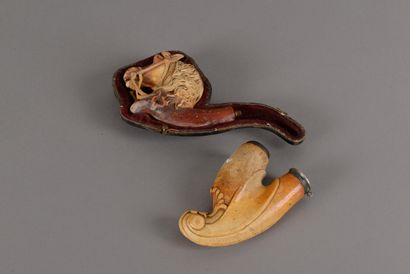 null Two scuplt meerschaum pipe stoves: one with palmettes decoration, one representing...