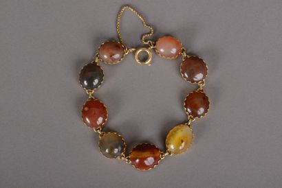 null Flexible bracelet in yellow gold 750 thousandths decorated with nine cabochons...
