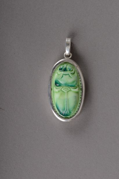 null Oval silver pendant decorated with a beetle motif in green painted glass paste,...