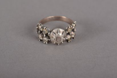 null Silver ring, the flat ring chased with lozenges, central motif set with rose-cut...