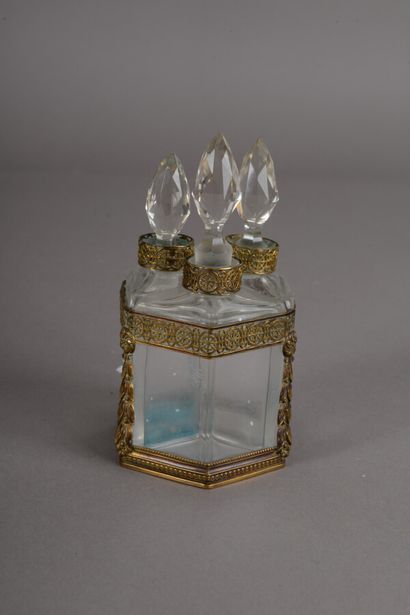 null Perfume cellar composed of three glass bottles of trapezoidal shape, brass trim...