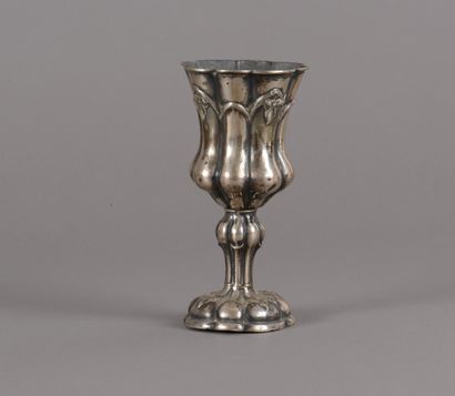 A silver chalice-shaped cup with a chased...