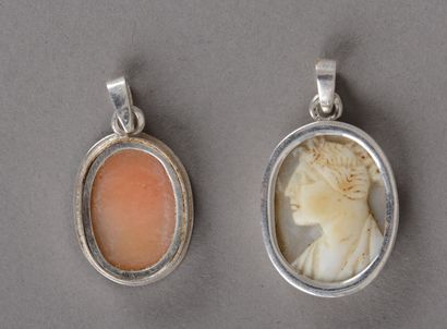 null Two oval silver pendants decorated with cameos representing female profiles...