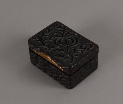 null A rectangular box in tortoise shell guilloche and carved with flowers and foliage...
