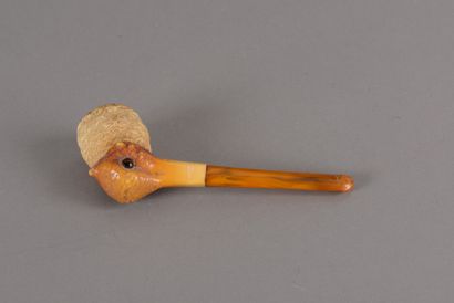 null A carved amber pipe representing a woodcock's head, the eyes in glass, the pipe...