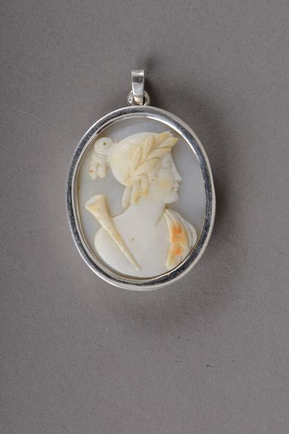 null A silver pendant with a cameo representing a young man wearing a laurel crown...