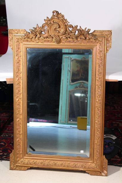 null Mirror with pediment, wood and gilded stucco frame decorated with scrolls, foliage...